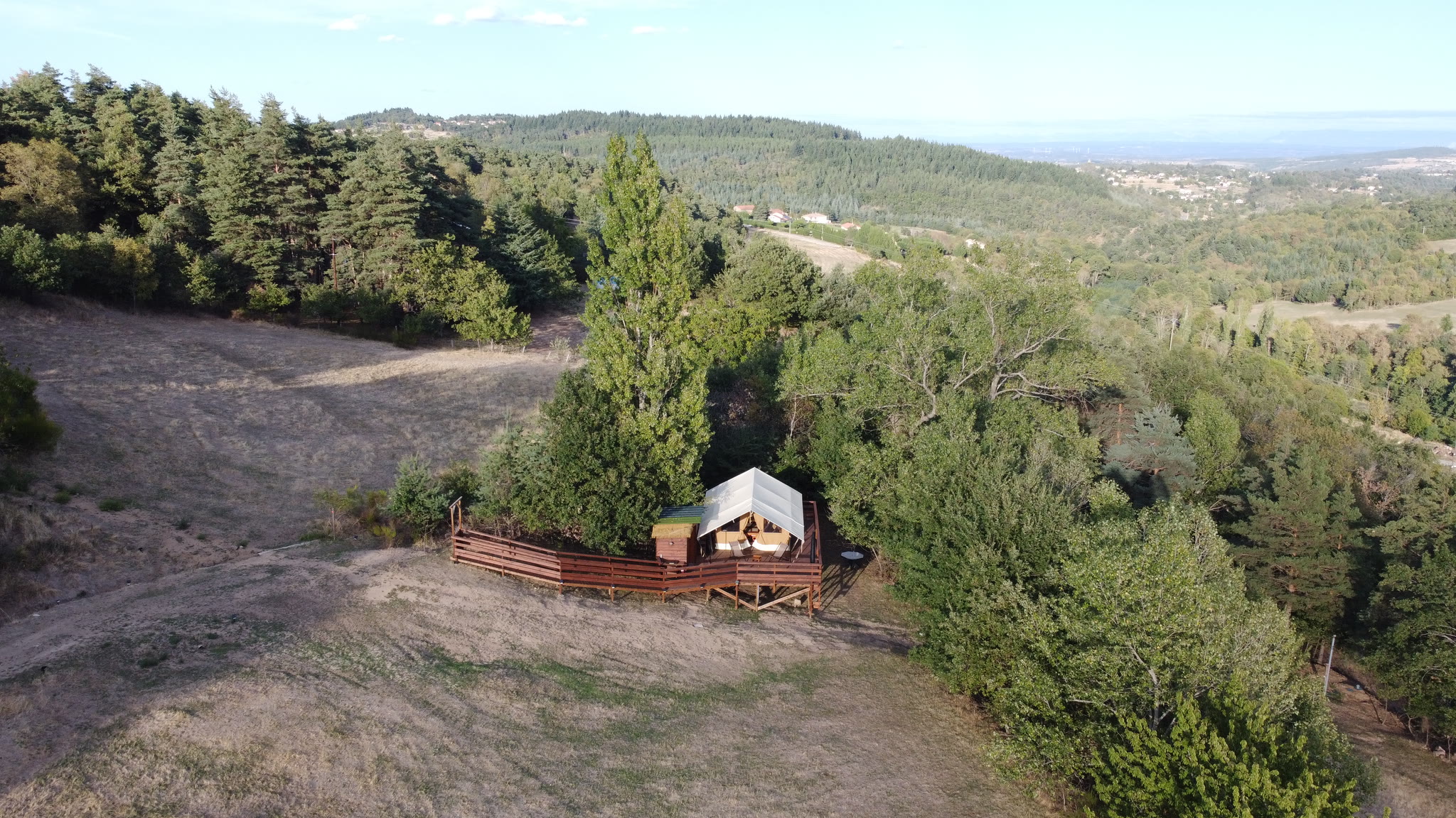 L'Estiva from the air, backing onto the trees, the woodland and the Ardèche valley to the horizon